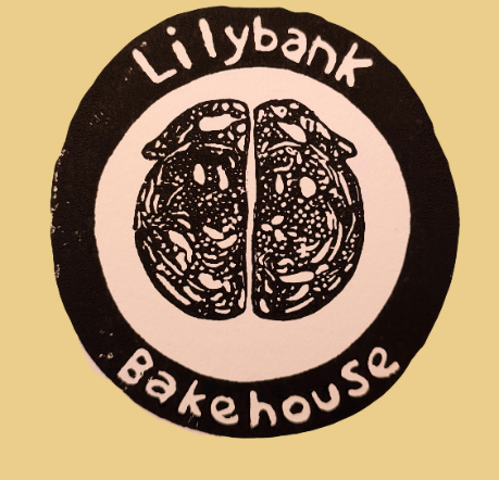 A round black and white logo with the text Lilybank Bakehouse surrounding an illustration of a sliced loaf of bread, perfect for a farm shop in Aberdeenshire that celebrates local produce and artisan baking.
